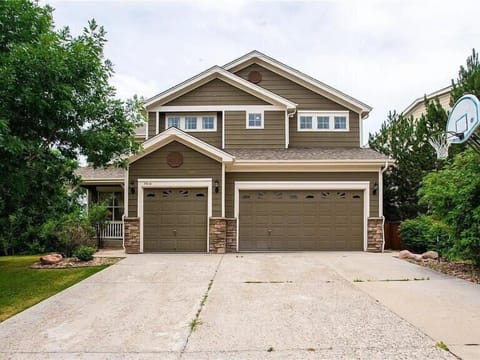 Modern two-story home with spacious garage and landscaped front yard in quiet residential neighborhood.