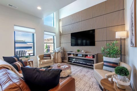 Bright living room with designer wall, fireplace, and smart TV.