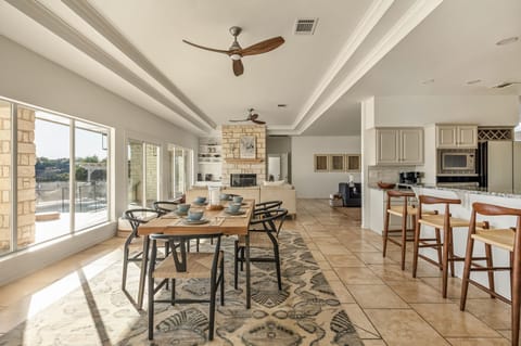 Dining table for 6 guests with additional seating on the kitchen top