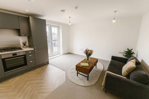 Enjoy an open-plan living space with lounge seating and a kitchen area at one end
