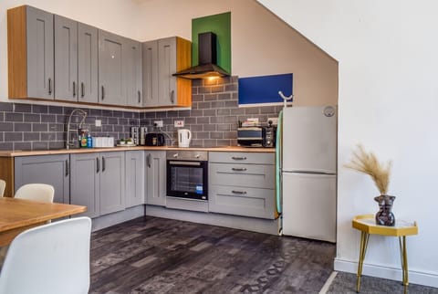 Cook up a feast in the modern kitchen with oven, hob, and full-height fridge.
