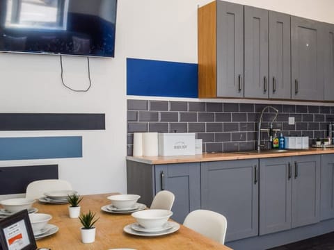 Dine at the table beside the kitchen units and splashback.