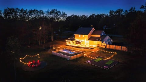 A magical nighttime view as the home glows warmly under the stars.