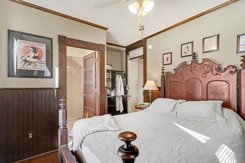 Queen-size bed on antique, solid wood frame with craftmanship details.