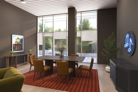 Spacious dining area featuring a large table, warm wood accents, and floor-to-ceiling windows.