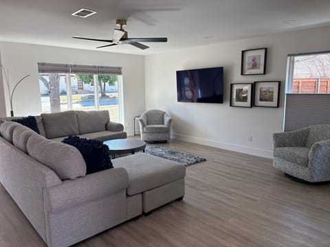 Open floor plan living area with 65 inch smart tv