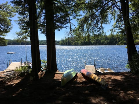 Peaceful lakefront setting with kayaks and dock ready for your waterfront adventures.