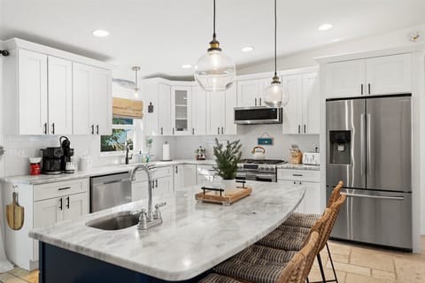 Kitchen: Chic marble island perfect for culinary adventures and laughter with friends!

