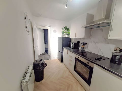 Another angle of the kitchen showing generous worktop space and appliances suited for longer visits.