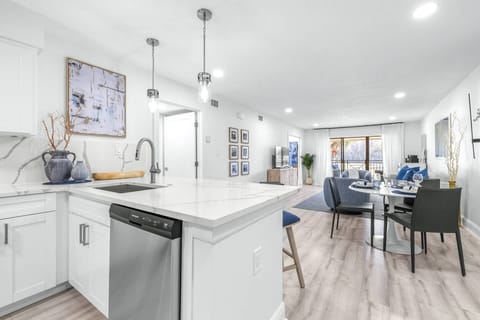 Updated kitchen with large island, quartz countertops, and stainless steel appliances.