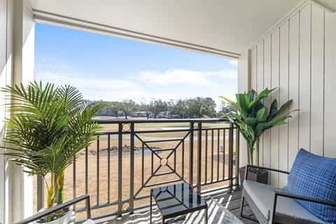 Private balcony overlooking the fairway and pond—perfect for morning coffee or sunset cocktails.