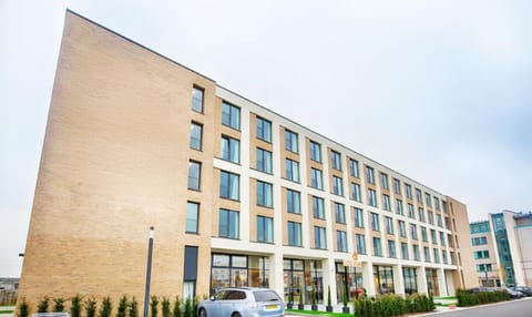 Arrive with ease at a modern, welcoming hotel frontage.