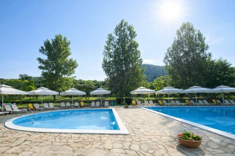 Swimming Pool with Sun Loungers and Forested Hills Creating a Tranquil Atmosphere