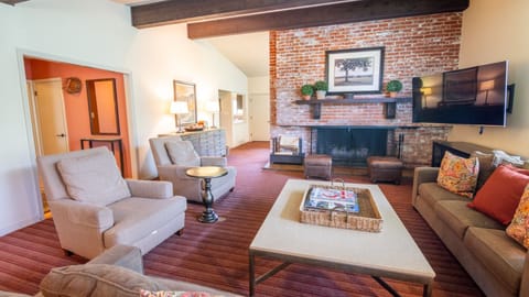 Kick back in the spacious lounge with a statement brick fireplace.