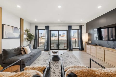 Sleek, modern lounge anchored by a charcoal sofa and designer accents.