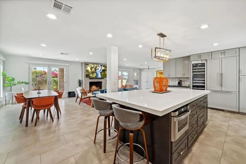 Kitchen with high end appliances, wine fridge and island.