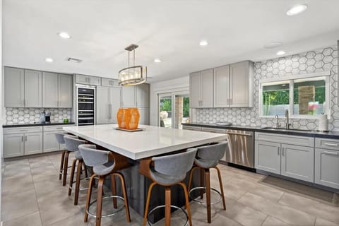 Kitchen with high end appliances, wine fridge and island.