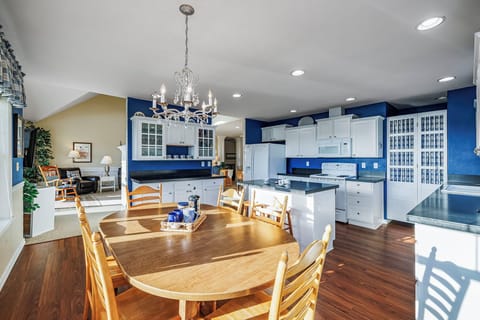 Open coastal kitchen with plenty of counter space and a dining table with seating for six, ideal for shared meals and conversation