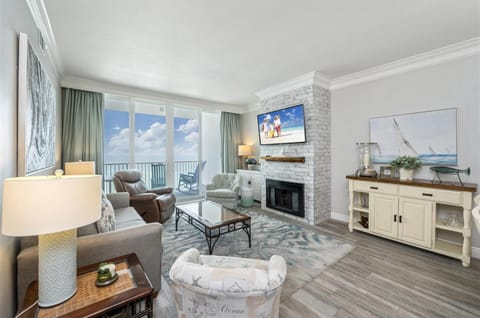 Unwind in your elegant living room with stunning ocean views, cozy fireplace, and coastal-themed décor perfect for relaxing after beach days.