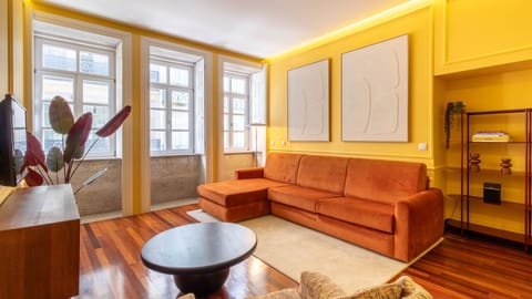 Bright living room with a plush rust-toned sofa, modern décor, and classic Porto windows filling the space with natural light.
#PortoApartment #StayInPorto #PortoLiving #DesignApartment #PortoTravel #PortugalStay #CityBreakPorto