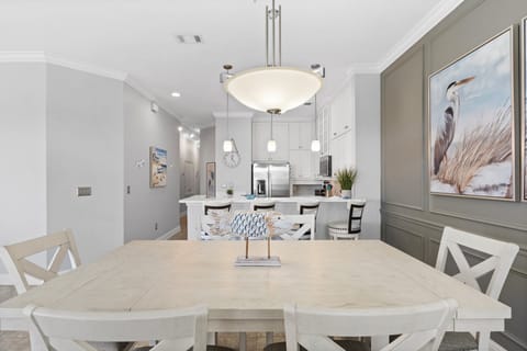 The light and airy dining area flows seamlessly into the fully equipped kitchen and breakfast bar.