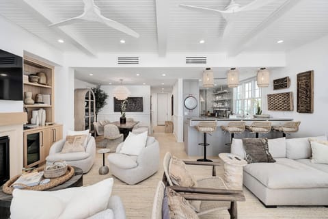 Sink into plush seating in your open-concept haven, where coastal elegance meets modern comfort in this stunning living space.