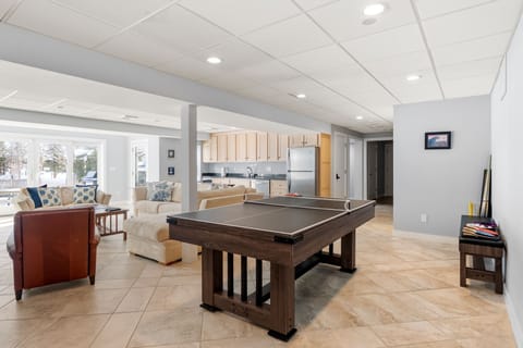 Game room with lounge, TV, ping pong/pool table & sauna.