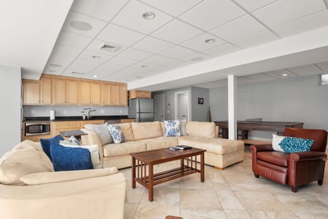 Game room with lounge, TV, ping pong/pool table & sauna.