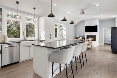 Full kitchen, island for 5, table for 4, TV, coffee bar & fireplace.