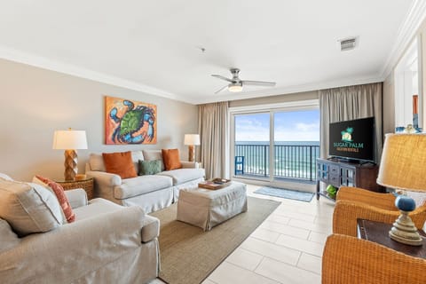Open living area features a large TV with plenty of seating.