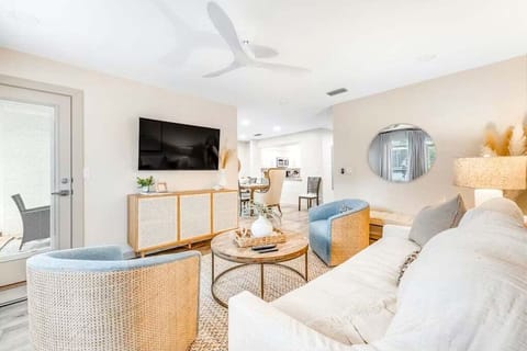 Bright and airy living room with 2 comfy swivel club chairs and oversize sofa for TV watching and just chillin' after a fun day on the court or at the beach.