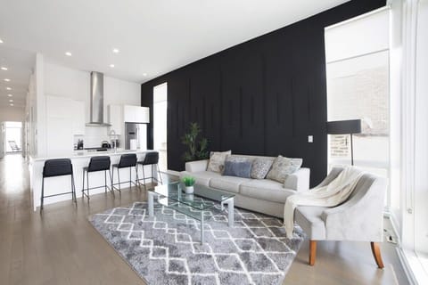 Sunlit open-plan living area w/ sleek finishes perfect for unwinding