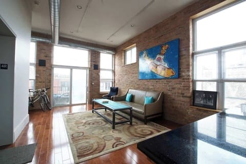 Bright first-floor living room w/ comfy seating & TV, perfect for relaxing after a day out.