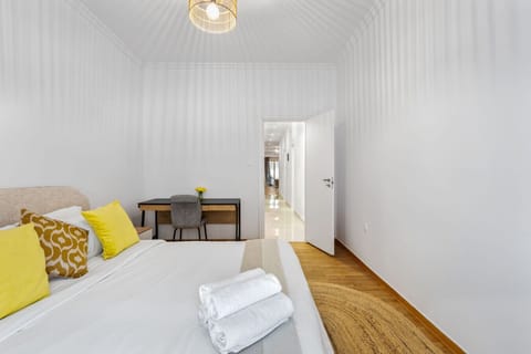 Bright master bedroom with workspace, ideal for remote professionals and long stays.