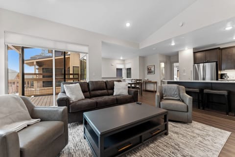 Living area with a gas fireplace, mounted TV, and queen sleeper sofa.