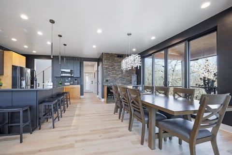 Fully stocked open concept kitchen with bar seating for 6 and dining table with seating for 8