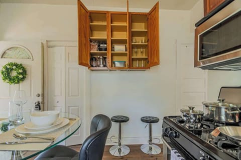 Kitchen detail w/ dining setup, wood cabinetry, & a welcoming everyday feel.

