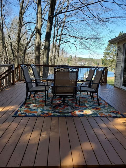 View from deck with lake visible beyond the neighboring property