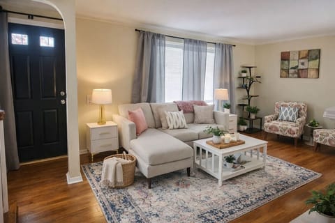 Relax and unwind in this bright and airy living space, featuring a cozy sectional sofa, and plenty of natural light. Perfect for morning coffee or a quiet evening in.