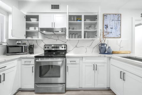 Well-stocked cabinets with dishes, glassware, and essentials — everything you need to feel right at home.