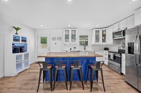 Bright, modern kitchen with full-size appliances, plenty of counter space, and seating for gathering over meals