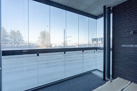 Spacious glass-enclosed balcony offering a bright, sheltered spot to enjoy the surrounding views.