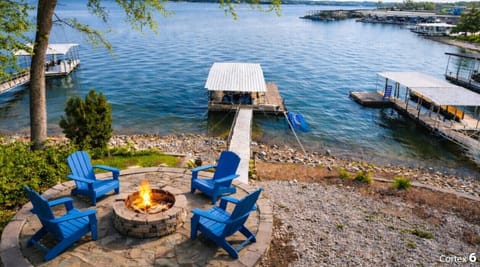 Lakefront home with private dock and fire pit just steps from Shady Gator — perfect for boating, sunsets, and Osage Beach nightlife.
