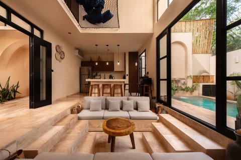 Open-plan living area with glass sliding doors connecting seamlessly to the pool terrace.