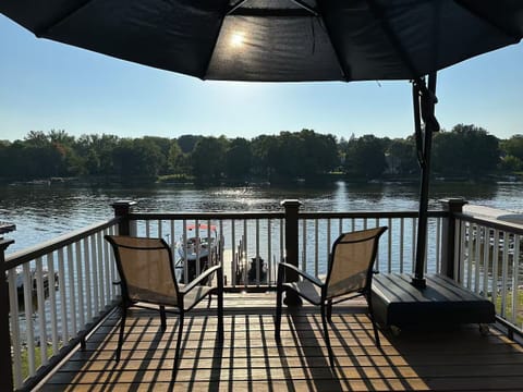 Seating on back deck under canopy umbrella with access to full river view.