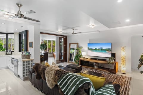 Bright open plan living connects the modern kitchen, lounge and indoor outdoor spaces. Relax on the spacious leather sofa, stream your favourites on the smart TV, and enjoy air conditioning, ceiling fans and a welcoming, light filled atmosphere.