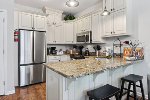 Modern chef's kitchen with barstool seating.