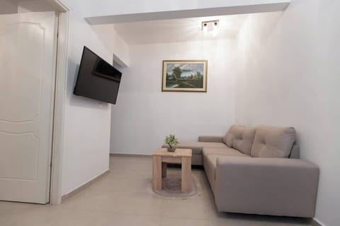 Bright and modern living area with Smart TV and comfortable seating.