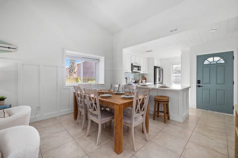 An open, sun-filled dining space that flows seamlessly into the kitchen — perfect for family meals, game nights, and vacation memories