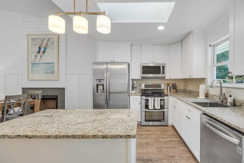 Spacious fully stocked kitchen with stainless appliances and ample counter space